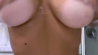 Busty babe playing with her big boobs