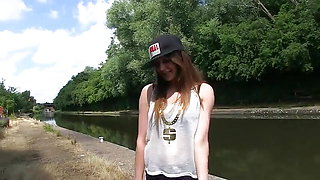 Busty brunette pissing outdoors for the camera