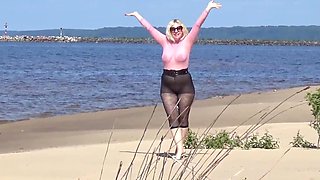 Jokey cougar with nylon caboose and breasts on beach