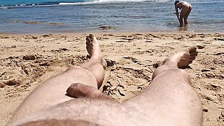 Stepsister gives nude blowjob to stepfather on a beach