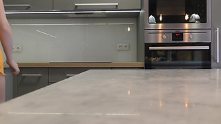 Long hair long legs hot blonde college girl on high heels and a miniskirt which does not cover her ass in the kitchen