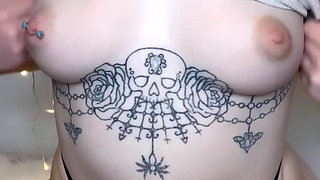 amateur tattooed blonde oils her pierced tits