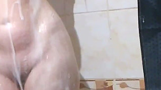 A Neighbor with Big Tits and a Big Ass Takes a Bath and Shaves Her Pussy