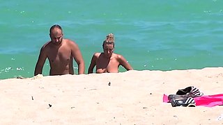 Hot nudist chick secretly filmed on the beach by a voyeur