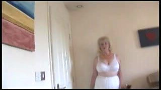 Mature busty lady in sheer slip strips